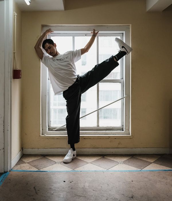 Man in a graceful warrior yoga pose showing strength and flexibility.